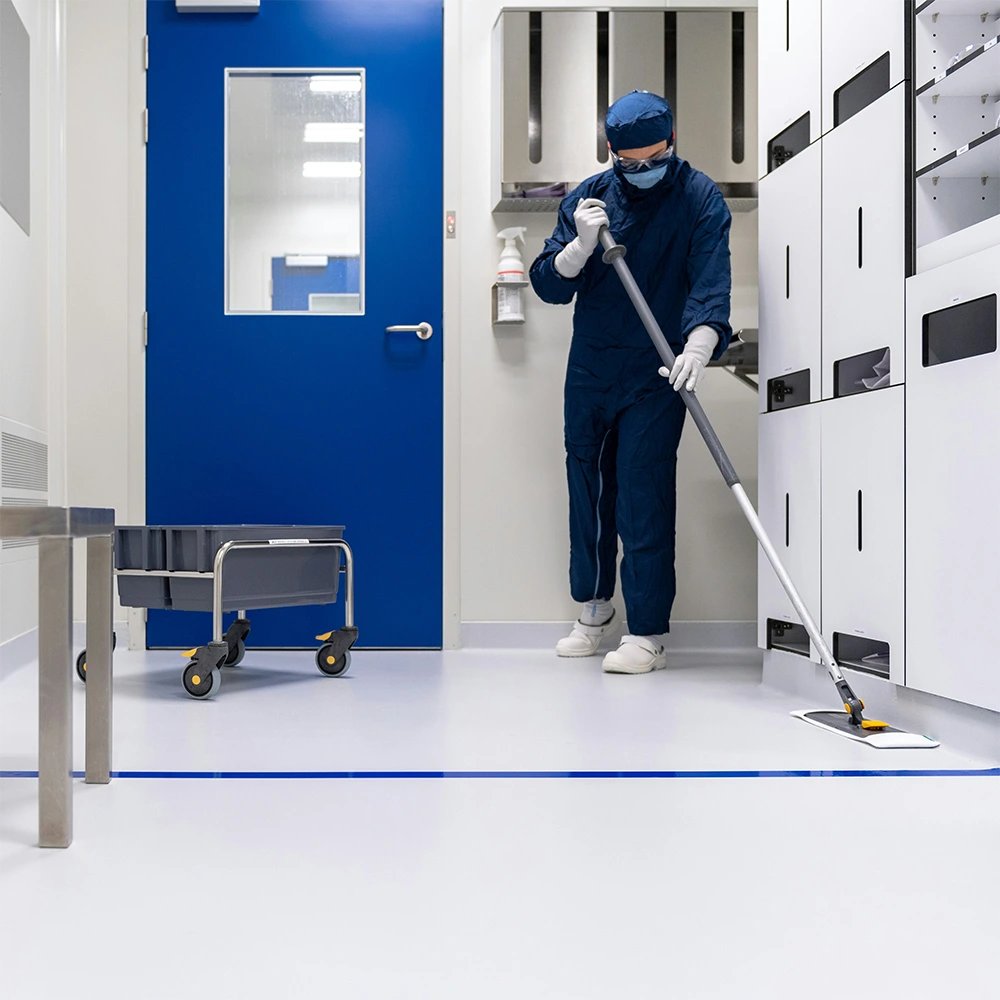 Professional commercial cleaning in Maui with cleaner mopping floor in a modern workspace
