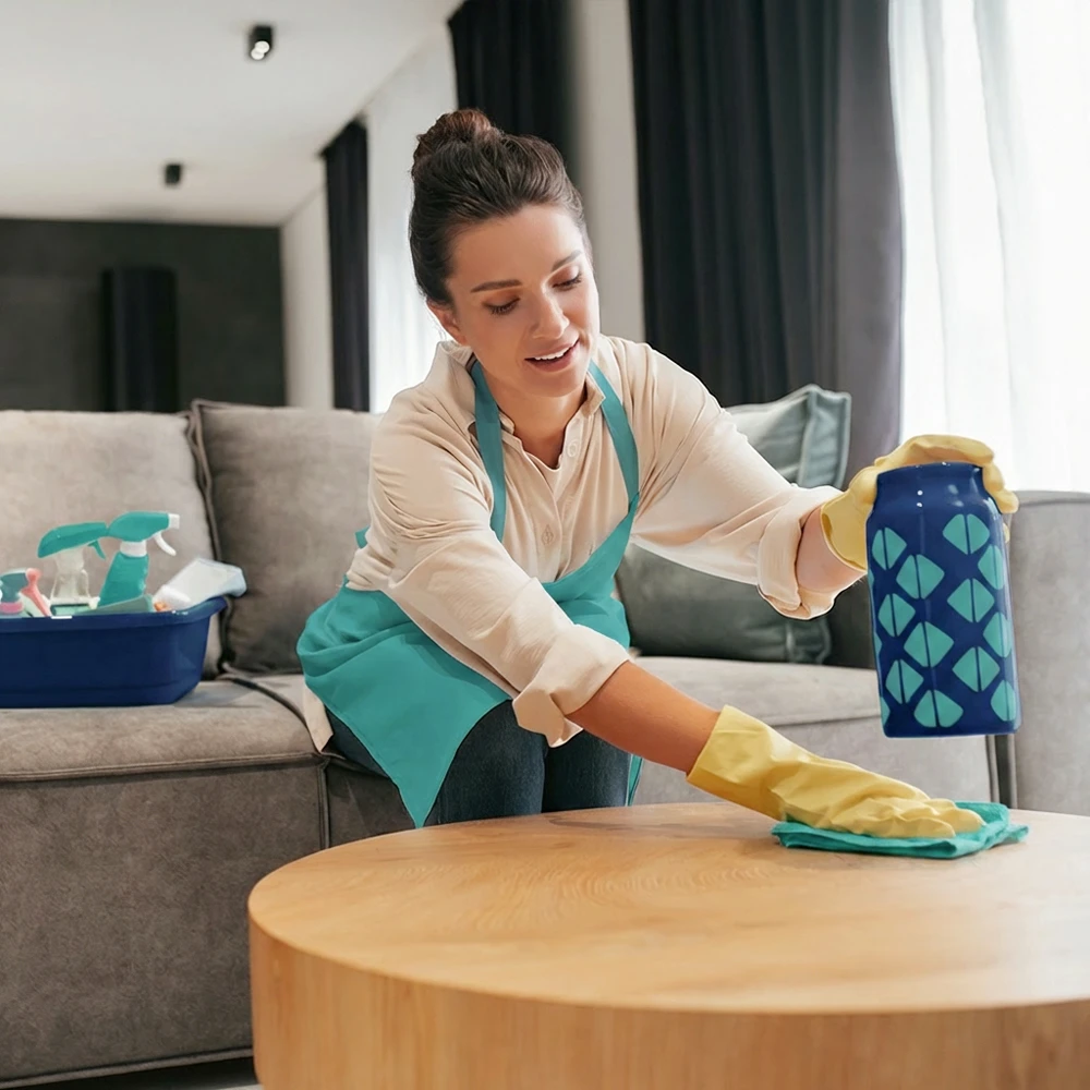 Vacation rental cleaning service in Maui with cleaner preparing a living room for guests